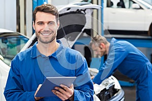 Smiling mechanic using a tablet pc