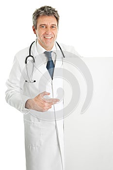 Smiling medical doctor presenting empty board