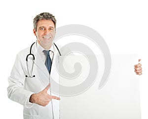 Smiling medical doctor presenting empty board