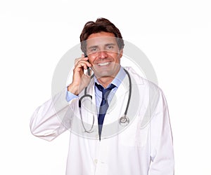 Smiling medical doctor speaking on cellphone