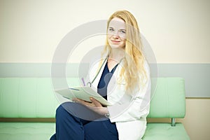 Smiling medical doctor with a stethoscope