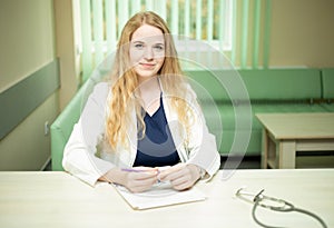 Smiling medical doctor with a stethoscope