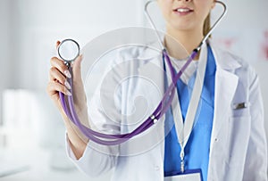 Smiling medical doctor woman with stethoscope in hospital