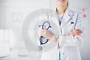 Smiling medical doctor woman with stethoscope in hospital