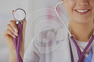 Smiling medical doctor woman with stethoscope in hospital