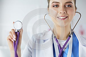 Smiling medical doctor woman with stethoscope in hospital