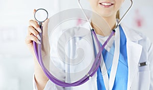 Smiling medical doctor woman with stethoscope in hospital