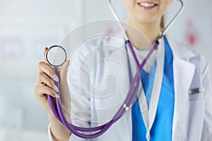 Smiling medical doctor woman with stethoscope in hospital