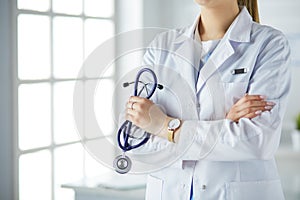 Smiling medical doctor woman with stethoscope in hospital