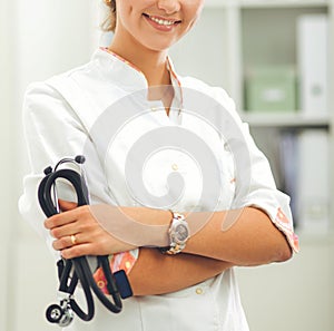 Smiling medical doctor woman with stethoscope in hospital