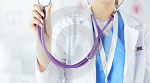 Smiling medical doctor woman with stethoscope in hospital