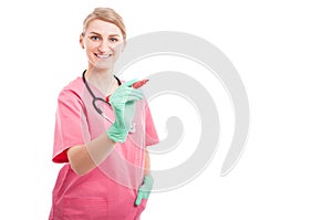 Smiling medical nurse lady writing on invisible board