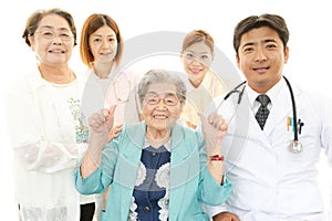 Smiling medical staff with old women