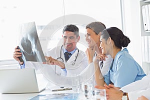 Smiling medical team analyzing xray