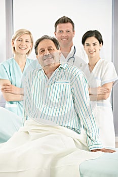 Smiling medical team with patient