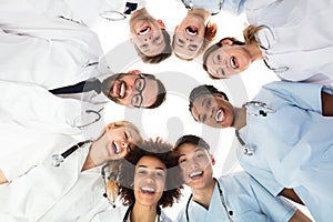 Smiling Medical Team Standing Against White Background
