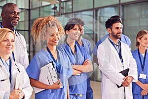 Smiling Medical Team Standing In Modern Hospital Building