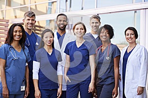 Smiling medical team standing together outside a hospital photo