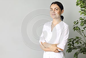 Smiling medical woman doctor overlight grey background photo