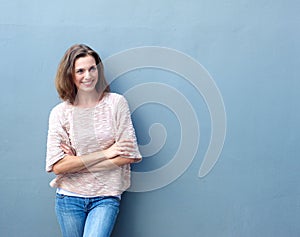 Smiling mid adult woman standing with arms crossed