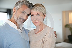 Smiling middle-aged couple at home