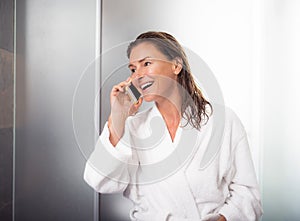 Smiling middle aged lady talking on cellphone