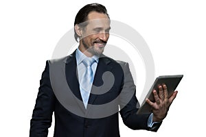 Smiling middle-aged male using digital tablet.