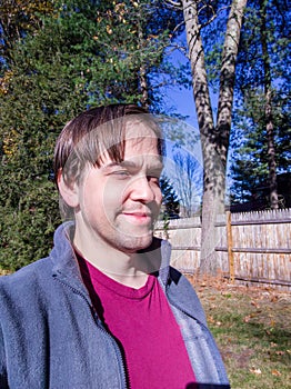 Smiling middle-aged man on sunny day