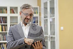Smiling Middle Aged Man With Tablet Computer
