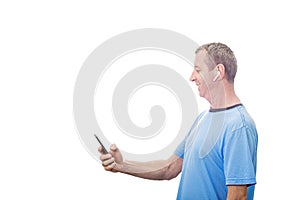 Smiling Middle aged man using  smartphone texting while listening to music over white background . Man listening to music or