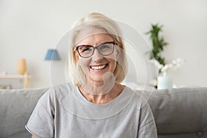 Smiling middle aged mature grey haired woman looking at camera