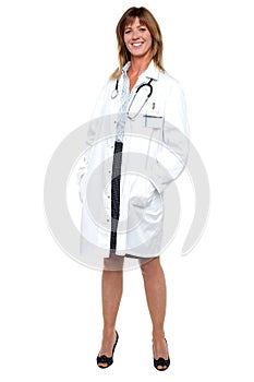 Smiling middle aged medical expert, full length portrait