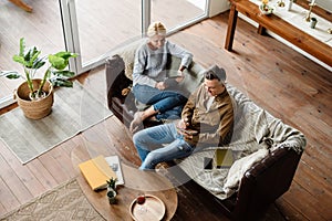 Smiling middle aged white couple relaxing on a couch