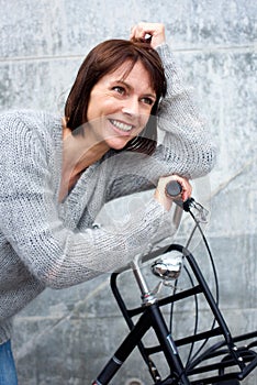 Smiling middle aged woman with bike