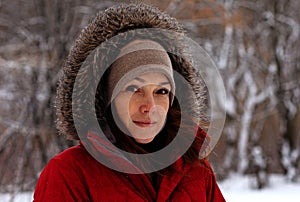 Smiling middle aged woman with calm look looking at camera in winter time