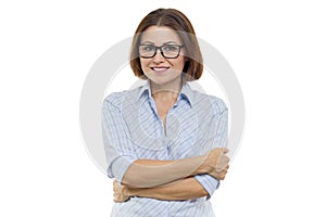 Smiling middle aged woman with folded arms on white background, isolated