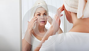 Smiling middle aged woman satisfied with her nature beauty. Cosmetic facial care concept