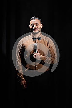 smiling middle east comedian performing stand