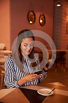 Smiling millenial in restaurant with tea