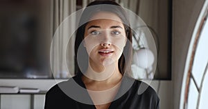 Smiling millennial professional indian businesswoman standing in office, portrait