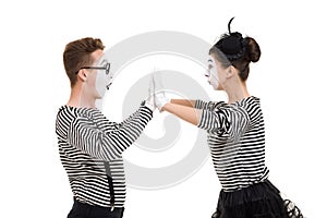 Smiling mimes in striped shirts.