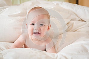 Smiling Mixed Race Baby Boy Having Fun on His Blanket