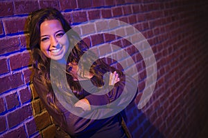 Smiling Mixed Race Young Adult Woman Against a Brick Wall