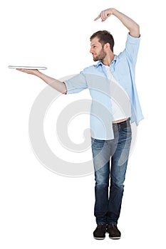 Smiling model holding laptop on right hand with flair