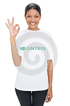 Smiling model wearing volunteer tshirt making okay gesture