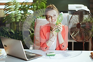 smiling modern bookkeeper woman in modern green office