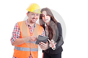 Smiling modern builder and business woman using wireless tablet