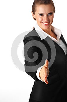 Smiling modern business woman stretches out hand f