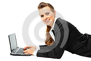 Smiling modern business woman using laptop