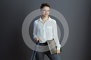 smiling modern business woman in white blouse isolated on gray